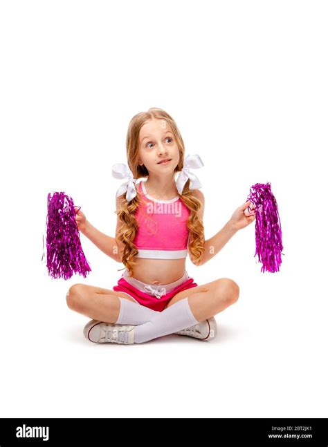 Long Haired Girl In A Pink Tank Top And Cheerleader Clothes Sitting