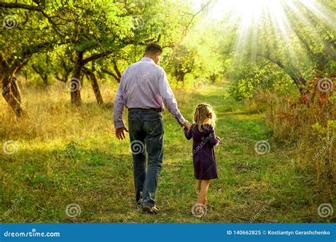 The Parent Holding The Child S Hand With A Happy Background Stock Image