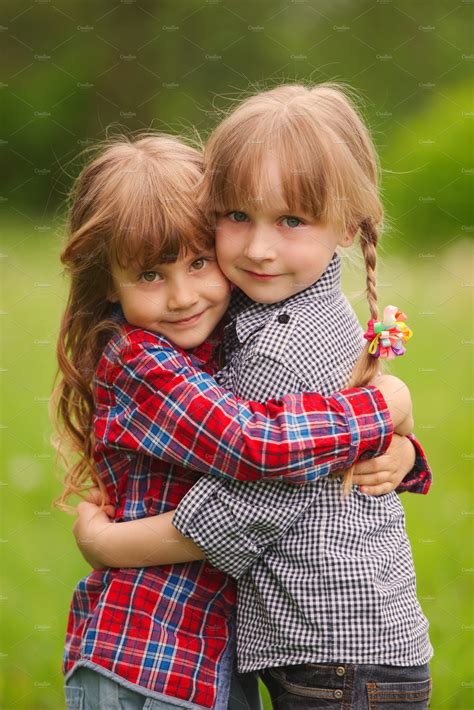 Two Girls Hugging Each Other On Featuring Two Beautiful And Children