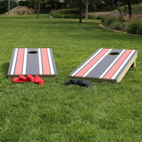 In this game, two teams throw bean bags into the holes of a goal board positioned on the ground to score points. Premium Cornhole Game (Custom Team Colors Stripes) | Tosso.com