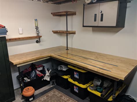 A Workbench With Lots Of Tools And Other Items On The Shelves In It