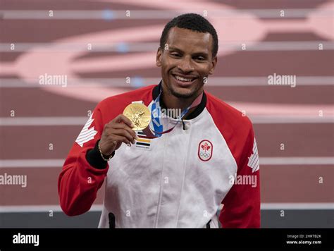 Canada‚Äôs Andre De Grasse From Markham Ont Holds Up The Gold Medal During A Ceremony For The