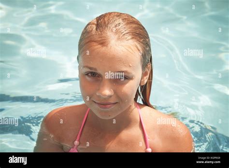 Beautiful Smiling Blond Girl Swims In A Pool Closeup Portrait Stock