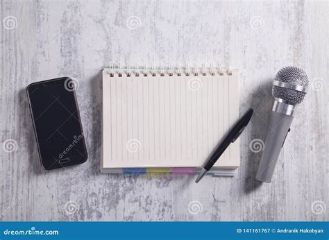 Microphone Smartphone Notepad And Pen On The Modern Desk Stock Image