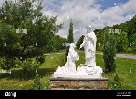 Statue Of The Virgin Mary Kneeling And Praying In Front Of Jesus In A