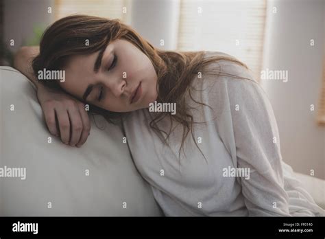 Tired Woman Falling Asleep On The Couch Stock Photo Alamy