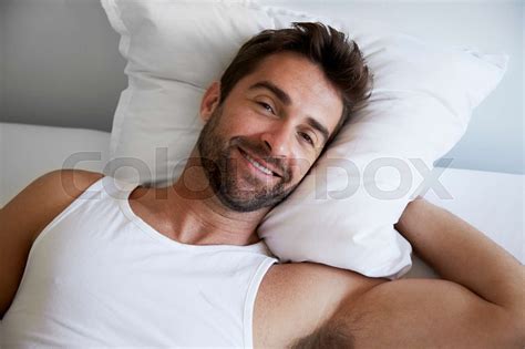 Smiling Man In Bed Stock Image Colourbox