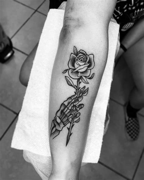 Skull Hand Holding Rose Tattoo By Diggylupitatattoo