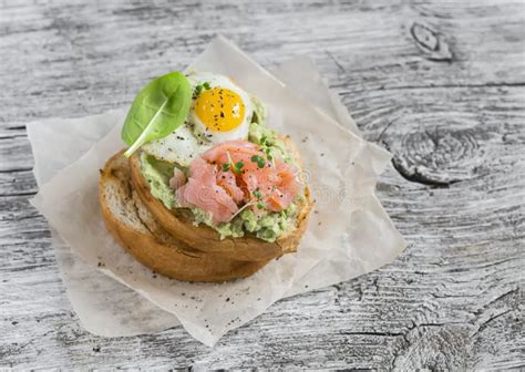 Mashed Avocado Sandwich With Smoked Salmon And Fried Quail Egg A