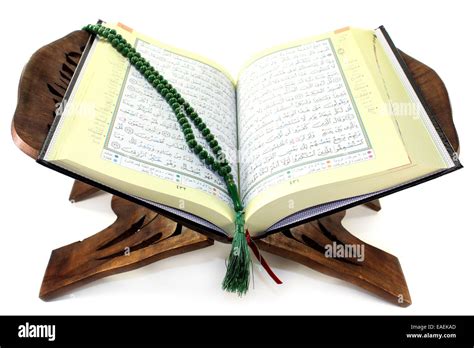 Quran With Quran Wooden Stand In Front Of White Background Stock Photo