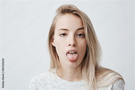 Disgusted Pretty Young Woman With Blonde Hair Sticking Out Tongue Expressing Her Dislike Or