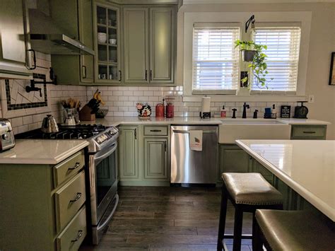 All the gleaming white cabinetry and and appliances is pretty overwhelming. American Foursquare kitchen. Sage green cabinets, white ...