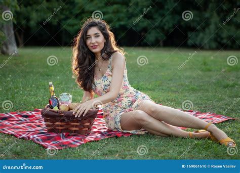 Brunette Woman On Picnic Blanket In The Park Stock Photo Image Of