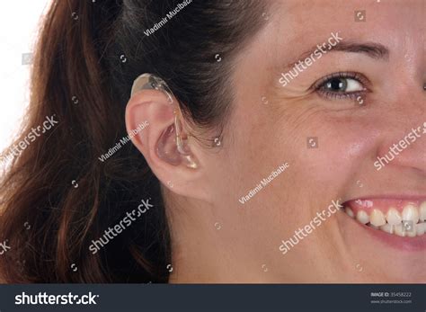 Beautiful Young Woman With Hearing Aid Closeup Shot Stock Photo