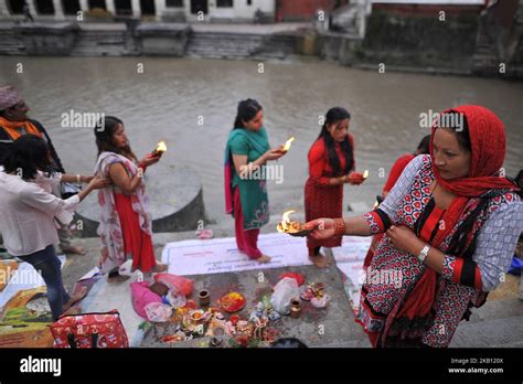 nepalese devotees offering ritual prayer at the bank of bagmati river of pashupatinath temple