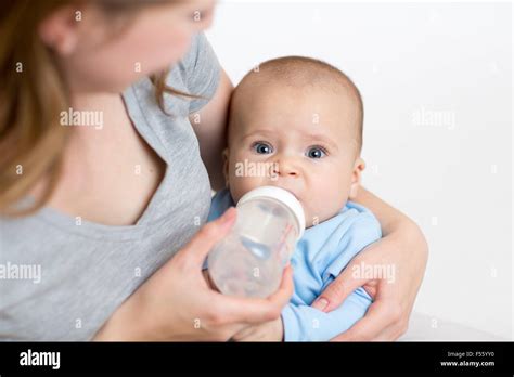 Mother Feeding Baby From Bottle Stock Photo Alamy