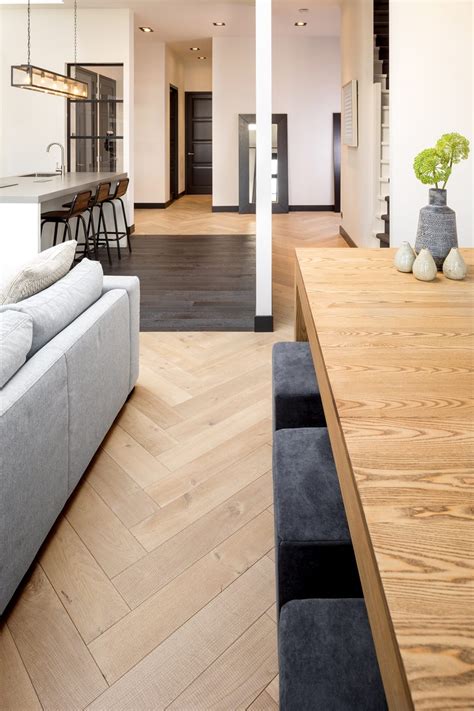 Centre modern furniture around a cubic rug. Hakwood Flooring - Modern Home Magazine