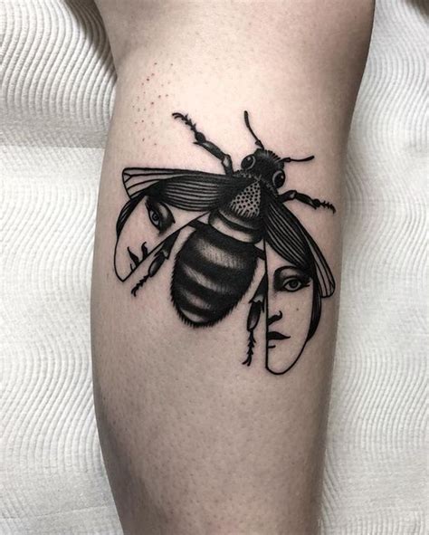 Black Bee Tattoo With A Face On Its Wings Bee Tattoo Tattoo Designs
