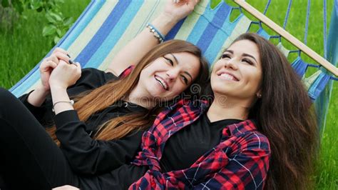 Lesbian Girlfriends Lie In Hammock In Garden Two Lesbians Woman Hug And Laugh Stock Video