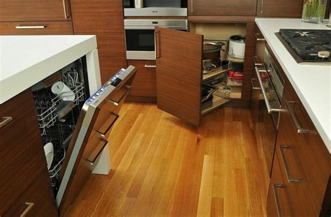 Baking dishes stacked in a corner storage space. Corner Drawers Are A Must-Have For Small Kitchens