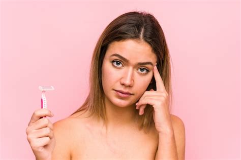 Premium Photo Young Caucasian Woman Holding A Razor Blade Isolated Young Caucasian Woman