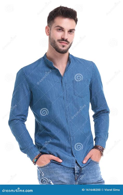 Handsome Casual Man Standing With His Hands In His Pockets Stock Photo