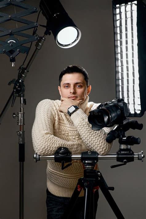Professional Handsome Photographer With Digital Camera On Tripod Stock