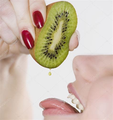 Woman Squeezing Kiwi Into Mouth Stock Photo Krivenko