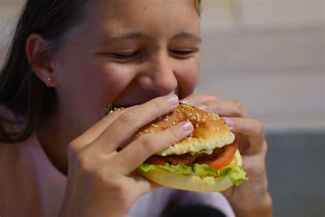 Girl Eating Delicious Fast Food Hamburger With Fries Stock Image