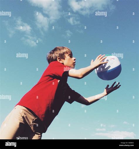 Boy Catching A Beach Ball Stock Photo Alamy