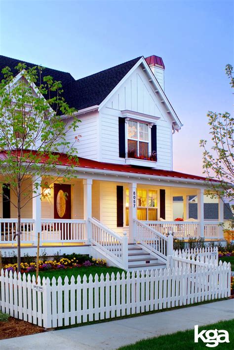 Traditional White Victorian Farmhouse With White Picket Fence By Kga