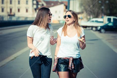 Two Beautiful Young Women Walking In The City Royalty Free Stock Image