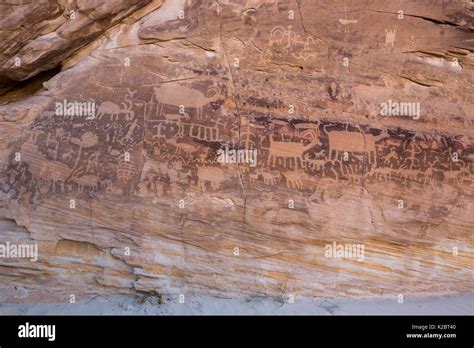 Native American Petroglyph Rock Art Is Carved Into The Aztec Sandstone