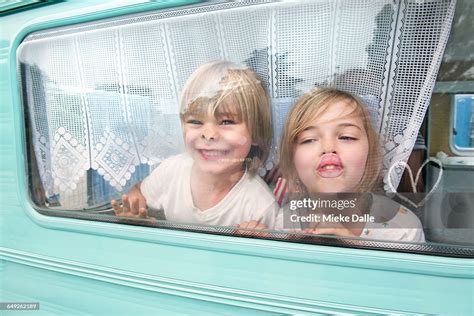 Children Pressing Nose And Lips Against Window High Res Stock Photo