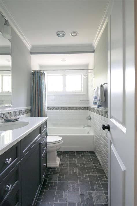 A beautiful kitchen white cabinetry on the main walls and a dark wood island with curved edges. Tiny hall bath, subway tile, dark floors, dark vanity ...