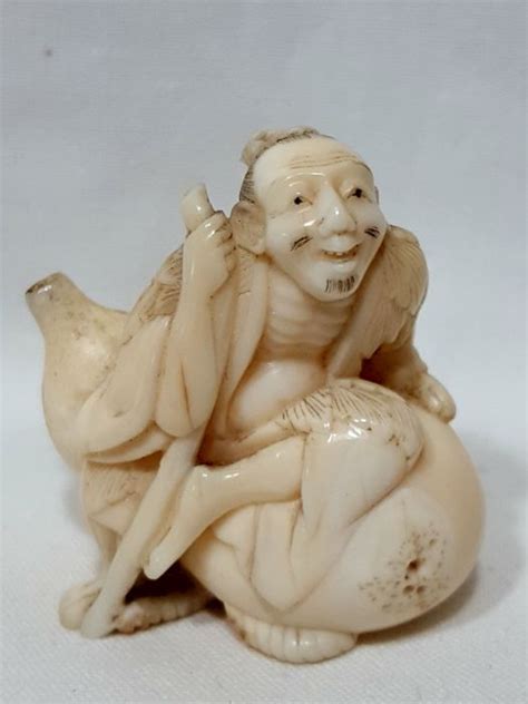 Another elongated netsuke with a curved top and bottom. Netsuke in marine ivory - Japan - late 19th century ...
