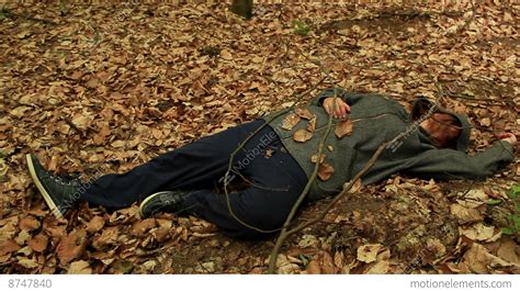 Dead Or Drunk Woman Lying On The Ground Among The Withered Leaves Stock