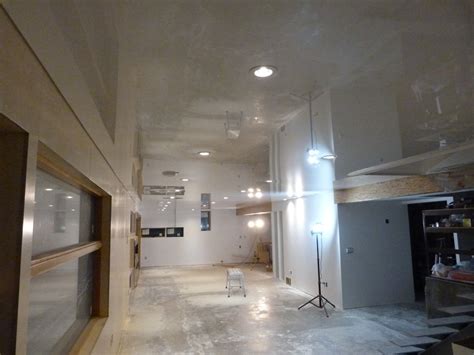 Suspended ceilings are one of the most popular basement ceilings. Basement Office transformation with a white high gloss ...