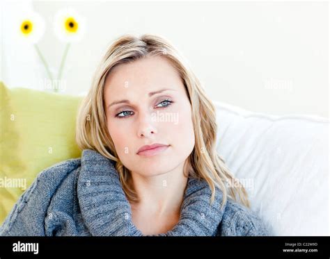 Exhausted Woman Lying On The Sofa With A Grey Pullover Stock Photo Alamy