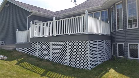 Wondering how to install deck railing on a wood deck? Azek deck XLM River Rock with Certainteed Kingston White vinyl railing with the Gothic Caps and ...