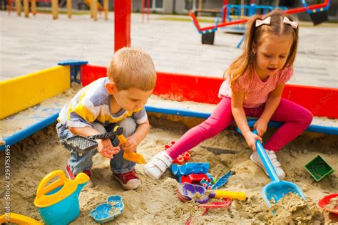 Adorable Little Kids Playing In A Sandbox Stock Photo Adobe Stock