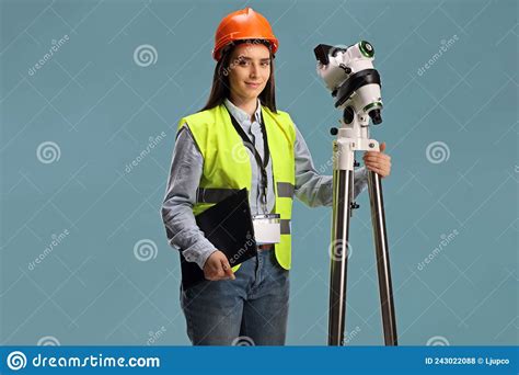 Female Geodetic Surveyor Posing With A Measuring Instrument On A Tripod