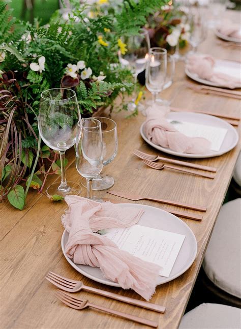Dusty Pink Wooden Tablescape With Greenery Centerpiece At A Private