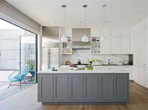 Custom white cabinetry, gray countertops and stainless steel appliances fill this elegant transitional kitchen. Classic and Trendy: 45 Gray and White Kitchen Ideas