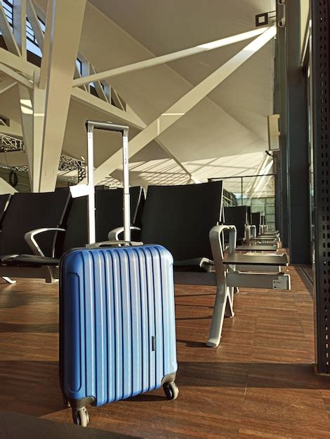 Premium Photo Blue Suitcase In An Empty Airport