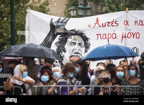 People attend the farewell ceremony held for the deceased Greek