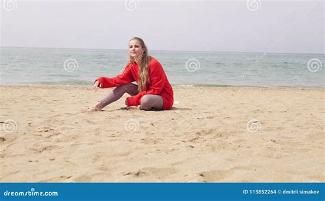 Blonde Girl Is Sitting On The Sand By The Sea And Posing For A Photo Shoot Stock Footage Video