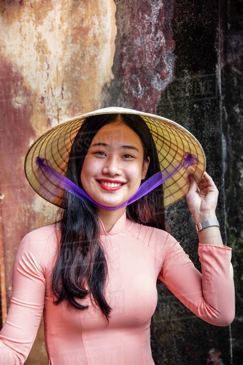 A Babe Vietnamese Woman In A Traditional Ao Dai Dress And Conical Hat And Smiling Hue Vietnam