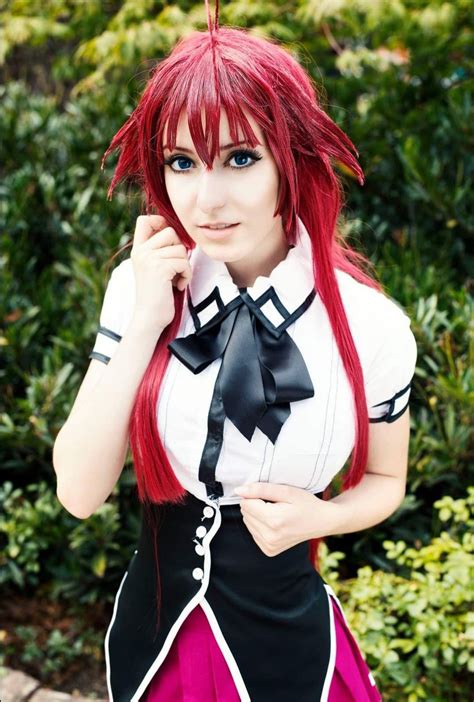 A Woman With Red Hair Wearing A Black And White Cosplay Outfit Posing