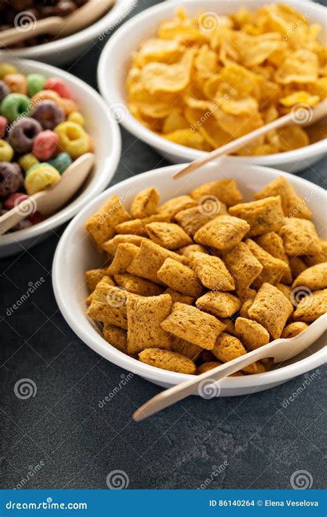 Variety Of Cold Cereals In White Bowls With Spoons Stock Photo Image